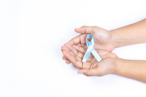 Two hands holding light blue ribbon, prostate cancer, white background Stock Photos