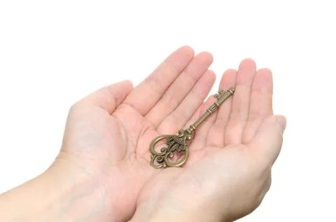 Two hands holding an old key Stock-Fotos