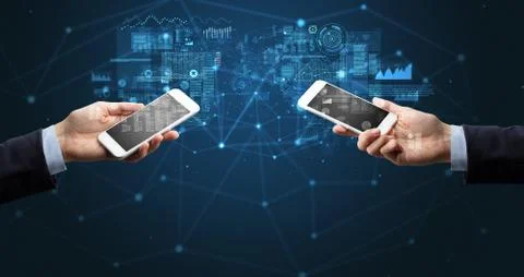 Two hands holding smartphones to sync business data Stock Photos