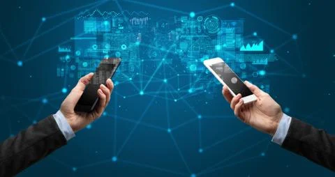 Two hands holding smartphones to sync business data Stock Photos