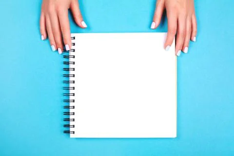 Two hands holding spiral notepad Stock Photos