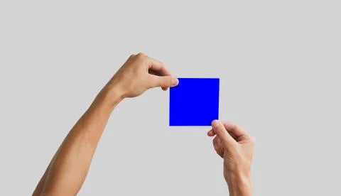 Two hands holding square paper in the hand. Leaflet presentation. Pamphlet .. Stock Photos