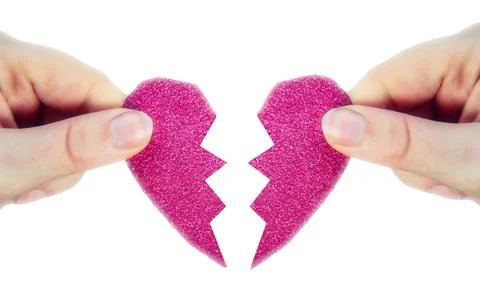 Two hands holding two halves broken pink heart into two parts together isolated Stock Photos