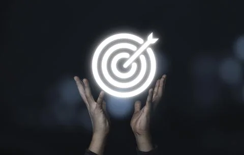 Two hands holding virtual white target board with arrow,Business Achievement Stock Photos