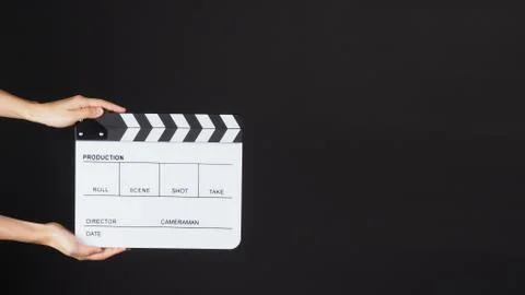 TWO Hands is holding white Clapperboard or movie slate. it use in video produ Stock Photos