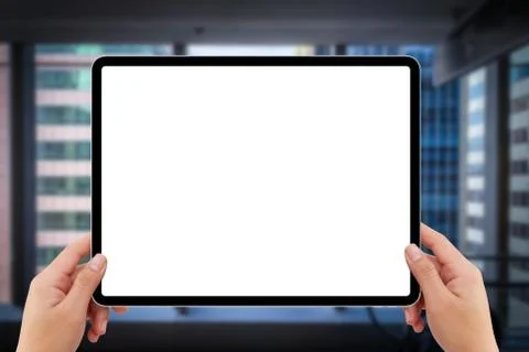 Two hands holding white screen mockup tablet computer in indoor shopping mall Stock Photos