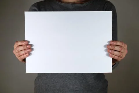 Two hands holding white sheet for copy space 库存照片