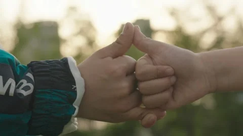 Two Hands Interlocking Fingers Outdoors at Golden Hour Stock Footage 339075426