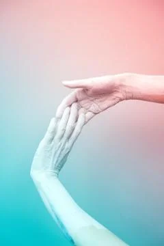Two hands join on a pink-blue background. Foto stock