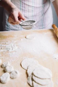 Two hands making dough for meat dumplings. Stock Photos