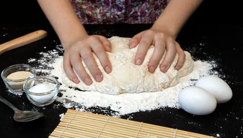 Two hands making a dough Stock Photos