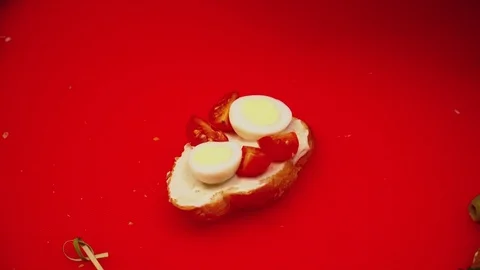 Two hands making tapas on cutting board with cheese and tomatoes closeup Video stock 77025760