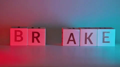 Two hands manipulate letter blocks spelling break and brake in different colors. Видео 338187733