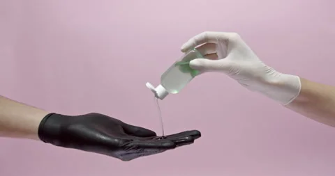 Two hands in medical gloves using sanitizers Stock Footage 146396228
