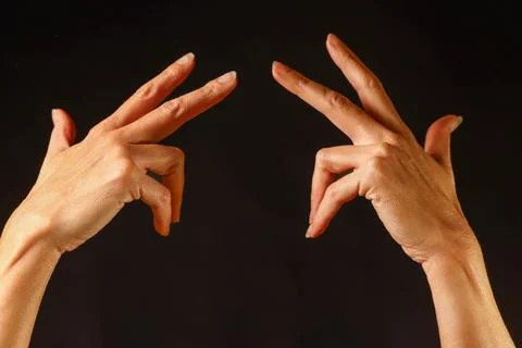 Two hands mirroring each other with bent index and middle fingers Stock Photos