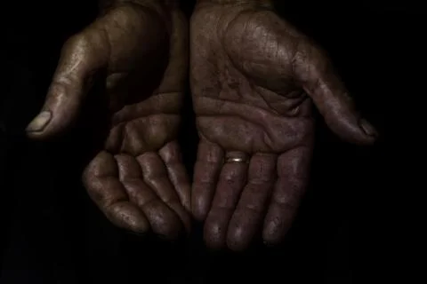 Two hands of an old man marked and soiled by work Stock-Fotos