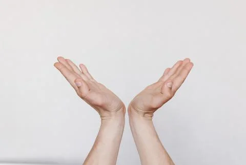 Two hands with palms up on a light background Stockfoto's