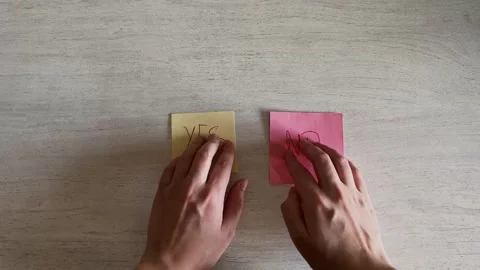 Two Hands Placing “Yes” and “No” Sticky Notes Decision Choice Stock Footage 324702499