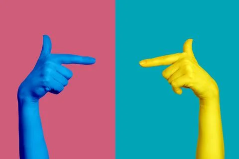 Two hands pointing at each other with the index finger. Trendy bright colors. Stock Photos