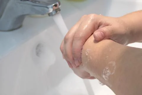 Two hands in the process of washing with soap Stock Photos