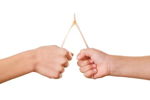Two hands pulling on a wishbone to break it Stock Photos