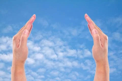 Two hands raised up on background sky Stock Photos