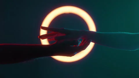 Two Hands Reaching Toward Each Other with Light Circle Stock Footage 313282975