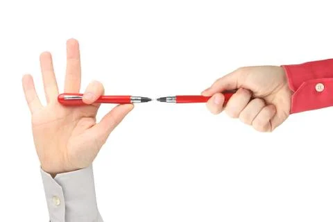 Two hands with red writing pens facing each other on white background Stock Photos