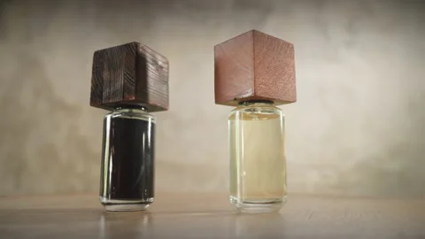 Two hands with rings and manicures put brutal perfume bottles in the frame Stock-Footage 170761816