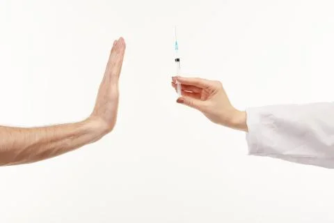 Two hands shown while giving and taking the medicine on the white background. Stock Photos
