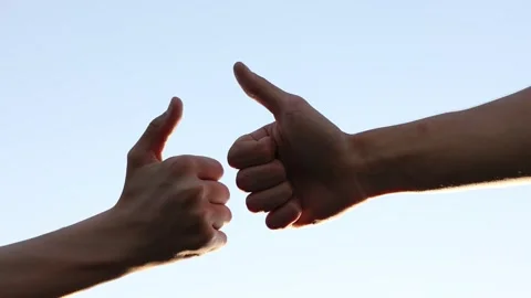 Two hands shows thumbs up on blue sky background. Big finger up. Approval. Stock-Footage 197442448