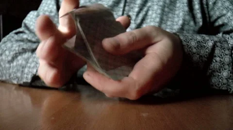 Two hands shuffling a deck of cards Stock Footage 43197035