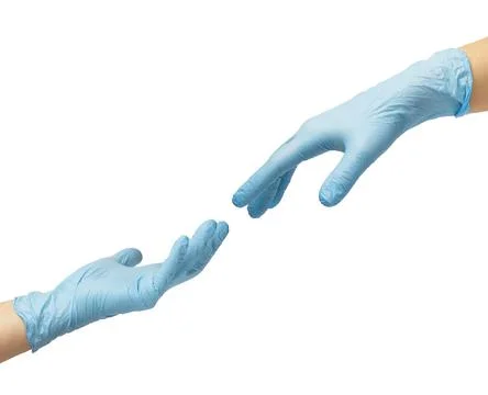 Two hands in sterile blue nitrile gloves reach out to each other. Stock Photos