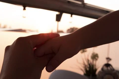 Two hands on sunset Stock Photos