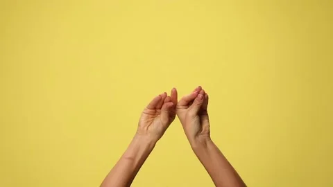 Two hands talking and babbling on yellow background Stock Footage 141392385