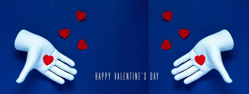 Two hands throw red hearts on a blue background. Book reversal. The concept f Photos