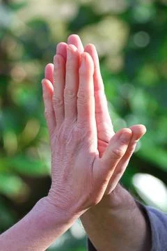 Two hands together making hi five gesture in nature Stock Photos