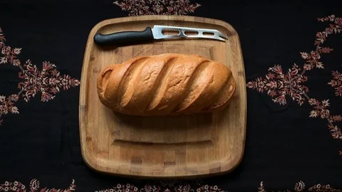 Two hands touch the bun on a wooden Board Stock Footage 102784138