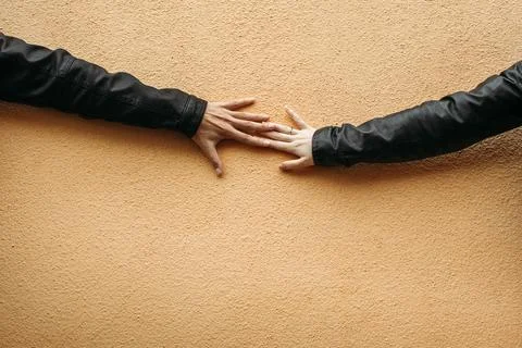 Two Hands Touching on Wall Stock Photos