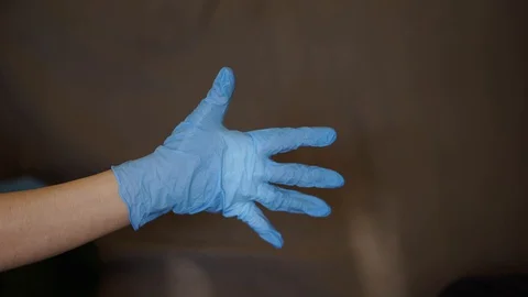 Two hands of two people in blue rubber gloves shake each other 스톡 동영상 129632893