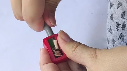 Two hands using pencil sharpener to sharpen pencil 스톡 동영상 313105086