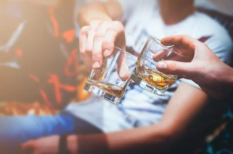 Two hands with whiskey Stock Photos