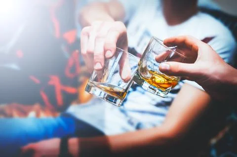 Two hands with whiskey Stock Photos
