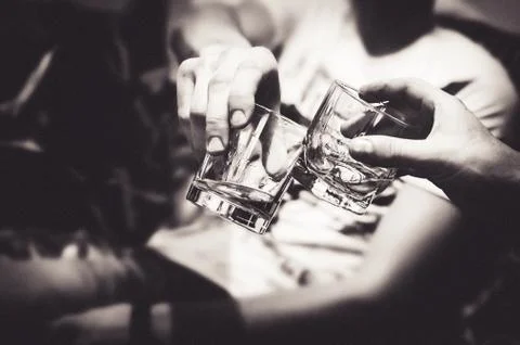 Two hands with whiskey Stock Photos