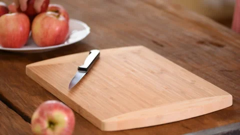 Two hands of a woman using knife to peel an apple skin. Stock Footage 116617718