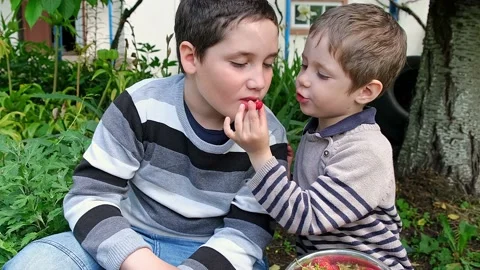 Two handsome boys sitting on the bench and smiling at camera. Stock Footage 158964931