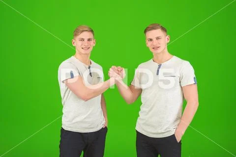 The two handsome twin greeting on the green background Stock Photos