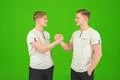 The two handsome twin greeting on the green background Photo