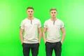 The two handsome twin stand on the green background Photo