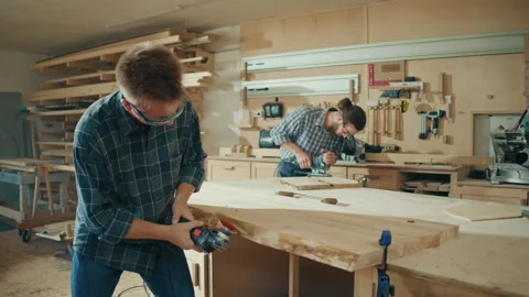 Two Handsome Young Men Carpenter Working at in a Studio with Tools on the Walls. Stock Footage 236469983